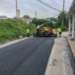 CMI Paving professionals pave an asphalt road as part of a commercial paving project